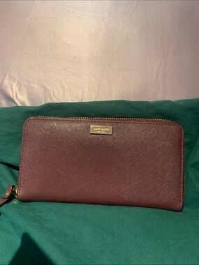 kate spade zip-around wallet in burgundy with gold hardware
